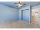 Light blue bedroom with ceiling fan and access to loft at 153 Sitka Spruce St, Henderson, NV 89015