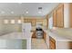 Modern kitchen with light wood cabinets and stainless steel appliances at 153 Sitka Spruce St, Henderson, NV 89015