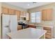 Modern kitchen with light wood cabinets and stainless steel appliances at 153 Sitka Spruce St, Henderson, NV 89015