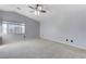 Main bedroom with ceiling fan, large window, and neutral carpet at 153 Sitka Spruce St, Henderson, NV 89015