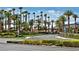 Gated entrance to community with lush landscaping and palm trees at 155 Marco Island St, Las Vegas, NV 89148