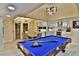 Game room with pool table, modern light fixture, and access to kitchen at 1716 Cochran St, Las Vegas, NV 89104