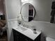 Bathroom with a round mirror and dark vanity at 2615 W Gary Ave # 2090, Las Vegas, NV 89123