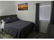 Well-lit bedroom with gray bedding and desert-themed art at 2615 W Gary Ave # 2090, Las Vegas, NV 89123