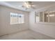 Bedroom with ceiling fan, window with blinds, and view to another room at 2894 Matese Dr, Henderson, NV 89052