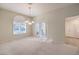 Bright dining room featuring a chandelier and French doors leading to the backyard at 2894 Matese Dr, Henderson, NV 89052