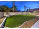 Landscaped backyard featuring artificial turf and attractive stonework at 336 Merit Ct, Henderson, NV 89014