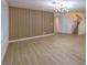 Open living area with a statement slatted wall and hardwood floors at 336 Merit Ct, Henderson, NV 89014