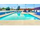 Community pool with blue tile and plenty of lounge chairs at 4614 Grand Dr # 1, Las Vegas, NV 89169