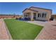 Spacious backyard with hot tub, patio, and artificial turf at 5528 Eleganza Ave, Pahrump, NV 89061