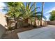 Spacious backyard with a patio, palm trees, and gravel landscaping at 10604 Royal Willow Pl, Las Vegas, NV 89144