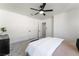 Well-lit bedroom with ceiling fan and carpet at 10965 Inverlochy Ct, Las Vegas, NV 89141