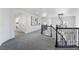 Upstairs hallway with gray carpeting and modern artwork at 10965 Inverlochy Ct, Las Vegas, NV 89141