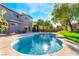 Inviting kidney-shaped pool with lush landscaping at 10965 Inverlochy Ct, Las Vegas, NV 89141