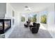 Bright sitting room with fireplace and window views at 10965 Inverlochy Ct, Las Vegas, NV 89141