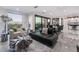 Modern living room with sectional sofa and large windows at 1168 Spago Ln, Henderson, NV 89052