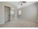 Spacious bedroom with mirrored closet doors and a window at 1788 Amarone Way, Henderson, NV 89012