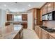 Island kitchen with granite countertops and wood cabinets at 1788 Amarone Way, Henderson, NV 89012