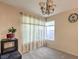 Bright dining room with leafy curtains and a chandelier at 1808 Cedar Bluffs Way, Las Vegas, NV 89128