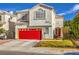 Two-story house featuring a red garage door and a red front door at 1808 Cedar Bluffs Way, Las Vegas, NV 89128