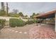 Backyard with covered patio, gravel landscaping, decorative rock borders, and gate at 1904 Plaza De Cordero St, Las Vegas, NV 89102