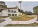 Community building exterior with stucco walls, arched windows, and grassy lawn at 1904 Plaza De Cordero St, Las Vegas, NV 89102