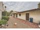 Exterior view of the home's back and side with a small patio and landscaping at 1904 Plaza De Cordero St, Las Vegas, NV 89102