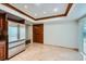 Kitchen with stainless steel refrigerator, wooden cabinets, and tile flooring at 1904 Plaza De Cordero St, Las Vegas, NV 89102