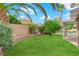 Lush green backyard with a water fountain, covered patio, and refreshing pool at 257 El Camino Verde St, Henderson, NV 89074