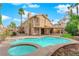 Inviting backyard oasis with a sparkling pool, spa, and covered patio at 257 El Camino Verde St, Henderson, NV 89074