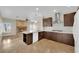 Modern kitchen with an island, stainless steel appliances, and dark wood cabinetry at 257 El Camino Verde St, Henderson, NV 89074