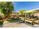 Backyard with covered patio, artificial grass, and lounge chairs at 280 Aqua Ln, Henderson, NV 89012