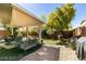 Relaxing backyard oasis with covered patio, artificial turf, and a grill at 280 Aqua Ln, Henderson, NV 89012