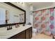 Double vanity bathroom with updated fixtures and a decorative shower curtain at 280 Aqua Ln, Henderson, NV 89012