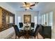 Bright dining room with glass-top table and four black chairs at 280 Aqua Ln, Henderson, NV 89012