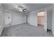 Bright bedroom with grey carpet, ceiling fan and ensuite bathroom at 402 Bell Ave, Henderson, NV 89015