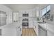 Bright kitchen featuring white cabinets, stainless steel appliances, and a large island at 5202 Misty Morning Dr, Las Vegas, NV 89118