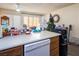 Kitchen features wood cabinets, island, and Amana dishwasher at 582 Grimsby Ave, Henderson, NV 89014