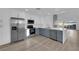 Modern kitchen featuring stainless steel appliances and white and blue cabinetry at 6940 Emerald Springs Ln, Las Vegas, NV 89113