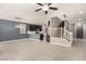 Open living room with tile floors, stairs, and modern chandelier at 6972 Placid Lake Ave, Las Vegas, NV 89179