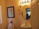 Small bathroom with toilet, sink, and framed art at 716 Solitude Point Ave, Henderson, NV 89012