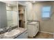 Bathroom with double sinks, granite countertop, and a walk-in shower at 8279 Palladium St, Las Vegas, NV 89113