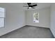 Well-lit bedroom featuring ceiling fan and carpet at 8412 Wildheart Ranch St, Las Vegas, NV 89131