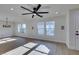 Living room with hardwood floors, multiple windows, and a stylish chandelier at 8412 Wildheart Ranch St, Las Vegas, NV 89131