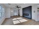 Bright and airy living room with hardwood floors and a contemporary fireplace at 8412 Wildheart Ranch St, Las Vegas, NV 89131