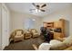 Home office with two wicker chairs, desk, and ceiling fan at 9103 Mcginnis Ave, Las Vegas, NV 89148