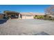 House exterior showcasing a three-car garage and additional covered parking at 10140 W Tropical Pkwy, Las Vegas, NV 89149