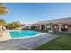 Relaxing rectangular pool with a patio and grassy backyard at 10140 W Tropical Pkwy, Las Vegas, NV 89149