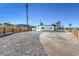 Newly renovated home with gravel driveway and wood fence at 103 Magnesium St, Henderson, NV 89015