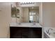 Double vanity bathroom with a large mirror and soaking tub at 6250 Buffalo Spring Ct, Las Vegas, NV 89122